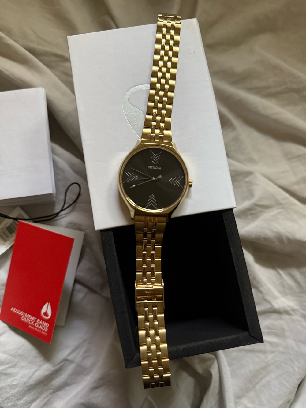 Nixon “The Clique” Gold Strap Bracelet Watch with Black Dial Women’s